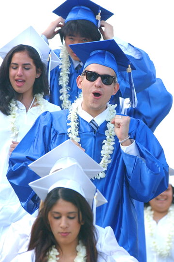 Borislav Tarasenko exuberantly walks into the Stadium-by-the-Sea for the commencement ceremony last Thursday.