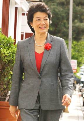 Flora Gil Krisiloff walks up the sidewalk on 26th Street at San Vicente, a corner which has the lowest zoning of any commercial area in the city, thanks to her efforts.
