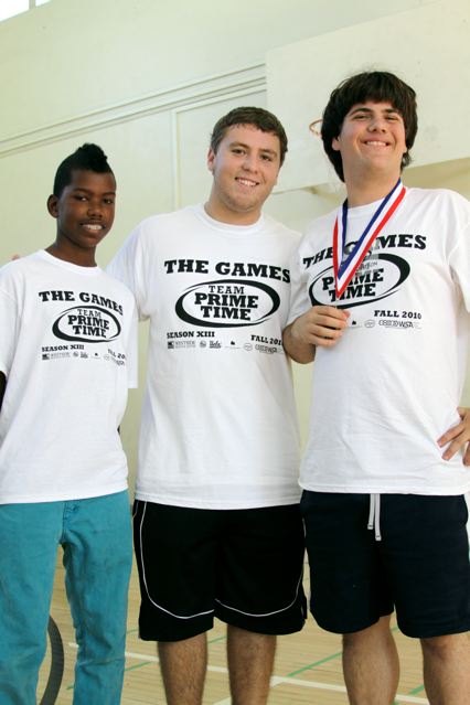 Palisades High football player Jeff Gaskin (center), President and founder of the Team Prime Time Club, with two of the friends he made during the 