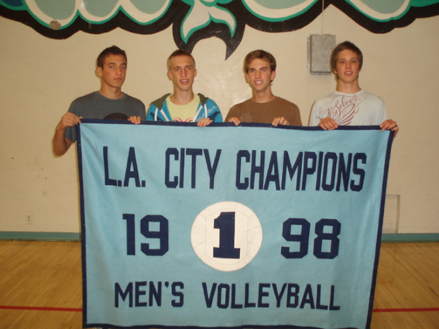 Jordan Cohen, Wylie Janousek, Taylor Savage and Matt Hanley hold the 1998 banner, one of many which will be on display at Palisades' first alumni volleyball match April 4.