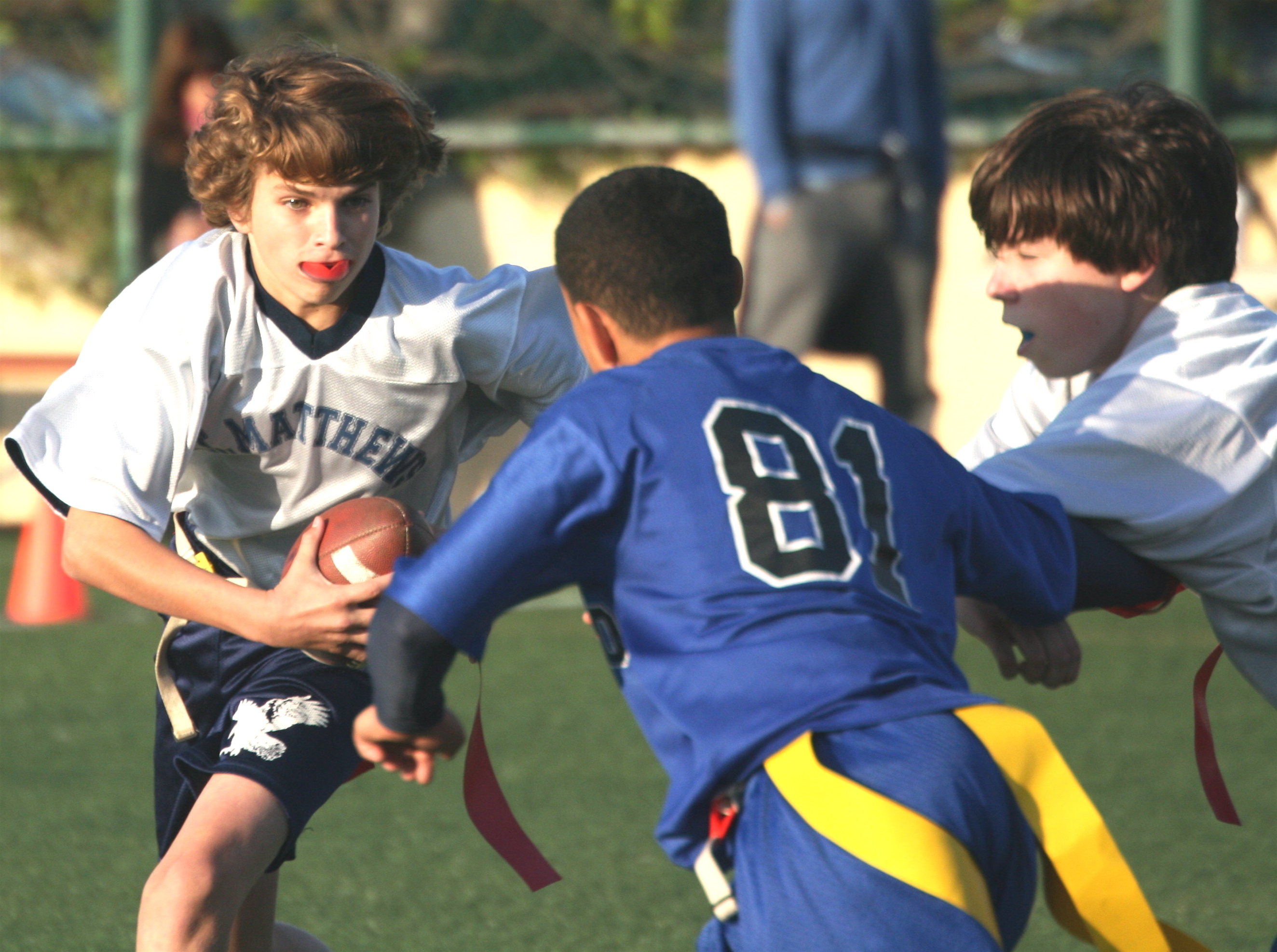 St. Matthew's quarterback Quinn McGinley (left) gets a block from Brendan Sanderson as he turns the corner in the championship game against Windward. Photo: Gigi McGinley