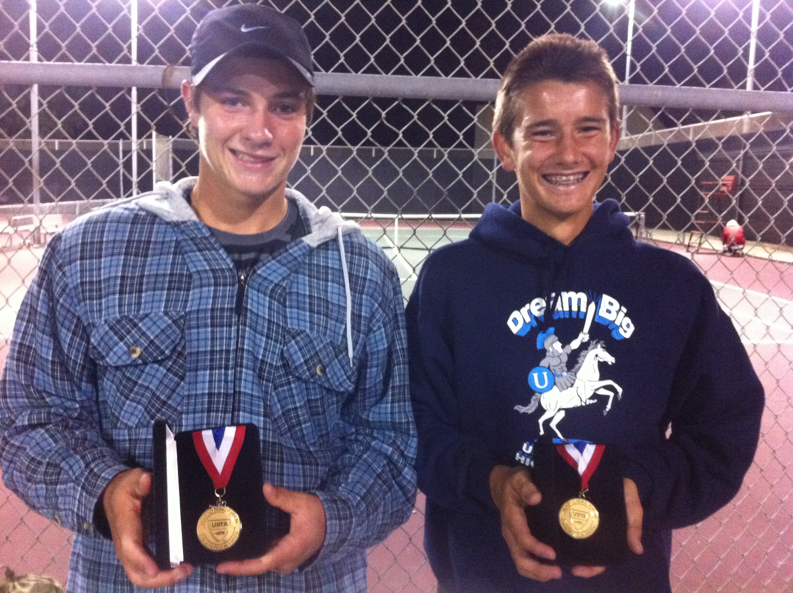 Robbie Bellamy (left) and partner Gage Brymer with their first-place medals after winning the 16s division at the USTA Nationals last weekend in Irvine.