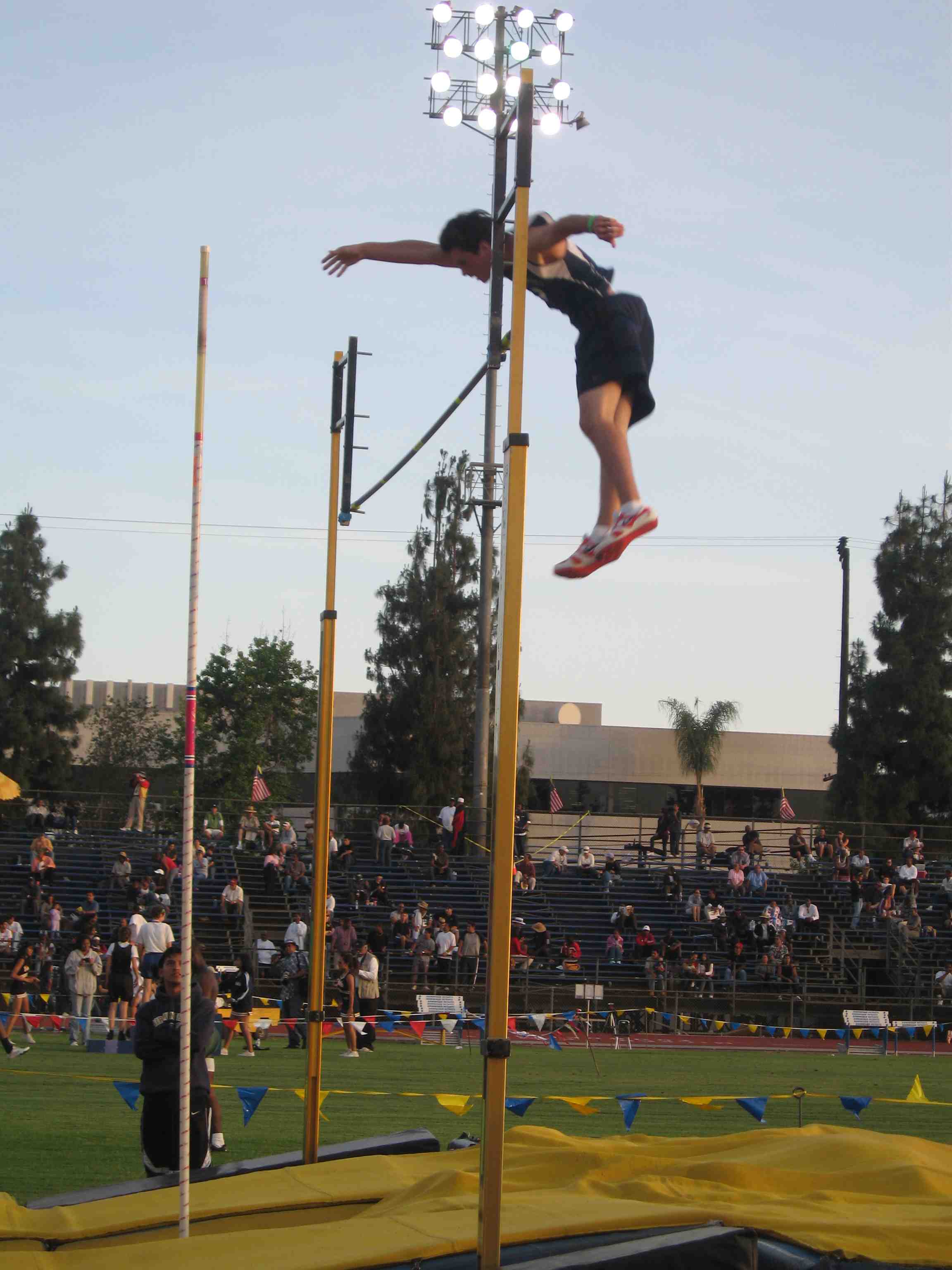 Palisades High senior Bryan Greenberg goes up and over the bar on his way to winning his second straight City pole vault title.  Photo: Debbie Price