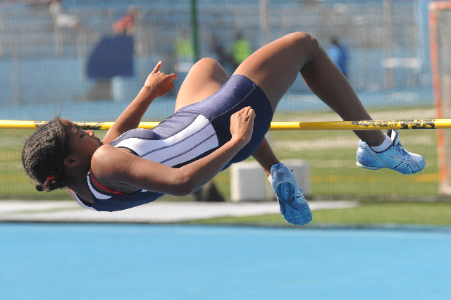 Mariah Fisher clears the bar on her way to winning the varsity high jump.