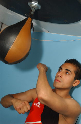 Carlos Arce sharpens his reflexes on the speed bag at Gerry Blanck's Martial Arts Center.