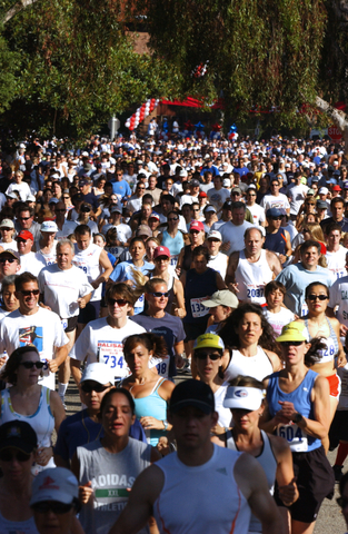 Runners head down Alma Real Drive at the start of last year's Palisades-Will Rogers 5/10K. The 30th anniversary race is July 4 at 8:15 a.m.
