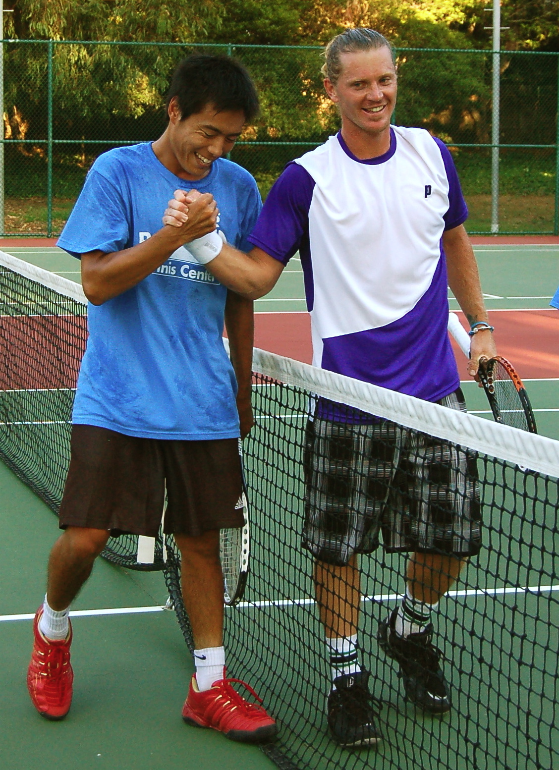 Winner Alex Bogomolov (right) shakes hands with runner-up Phillip King after their epic match in the 