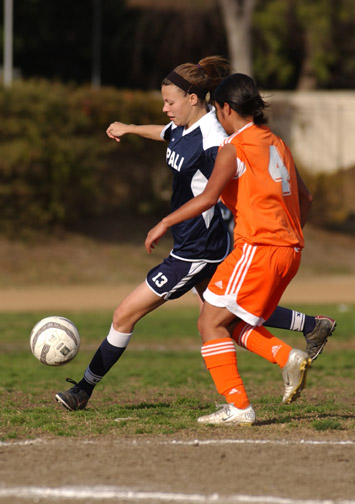 Lauren Pugatch (wearing blue) and the Palisades High women's soccer team overcame a halftime deficit to beat University, 2-1, in the L.A. City Section Invitational finals Saturday afternoon at East L.A. College.