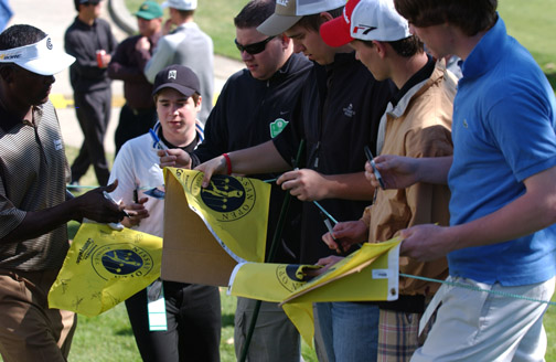 Pro golfer Vijay Singh (left) signs autographs after a practice round Tuesday in preparation for the Nissan Open, which starts today at Riviera Country Club.