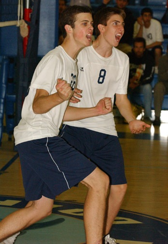 Scott Vegas (left) and Daniel Deloje celebrate after combining for a block. Palisades outlasted University in five games last Friday to stay in second place in the Western League.