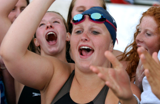 Dolphins (from left) Hayley Lemoine, Jasmine Punch and Sabrina Giglio celebrate after they clinched the City Section swim title last Wednesday.