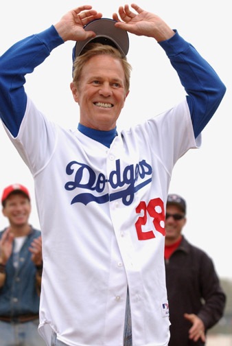 Retired Dodgers first baseman Wes Parker tips his cap to fellow Palisadians before catching the first pitch from Maria Shriver to open the PPBA season.