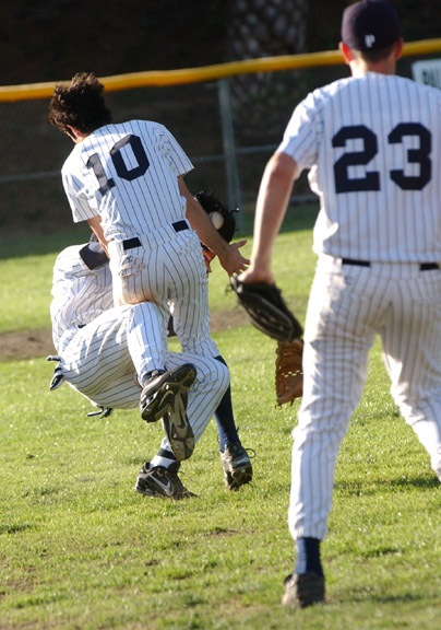 Third baseman Jonathan Moscot (#23) watches short stop Andy Megee (#10) collide with left fielder Eric Verdun in pursuit of a pop fly in the sixth inning of Monday's game against Roosevelt, which scored on the botched play.