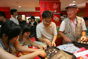 Palisadian Bud Kling assists three Chinese customers at his trading table in the Olympic Village in Beijing during the 2008 Olympic Games.	Photo courtesy of Bud Kling