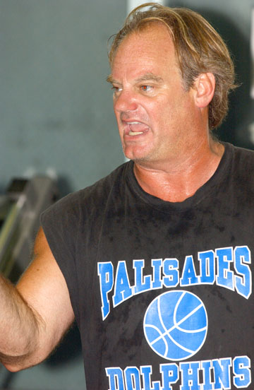 Palisades High head football coach Kelly Loftus talks to his players at a meeting Monday in the weight room.