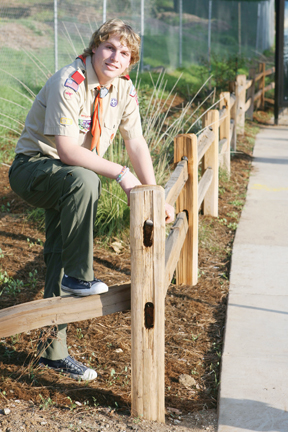 Carter Grasmick, with Boy Scout Troop 117, pulled weeds, laid mulch and built a fence at the front of the YMCA's Simon Meadow property along Sunset Boulevard, at the entrance to Temescal Gateway Park.