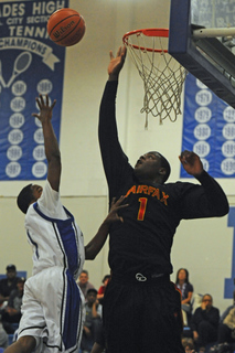 Fairfax's 6-11 center Renardo Sidney (right) leaps to block a shot by Palisades captain Lebre Merritt in the Dolphins' 89-54 league loss Monday.