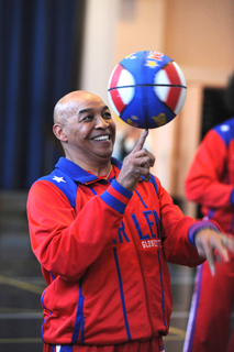 Harlem Globetrotters legend Curly Neal spins the ball on his finger to the delight of Corpus Christi students and teachers on Tuesday.