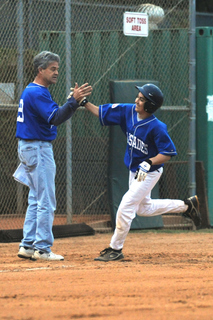 Pali Blue Coach Ben Nethercot high-fives his son Jackson, who rounds third base after hitting a home run in the first inning last Friday night against Pali White.