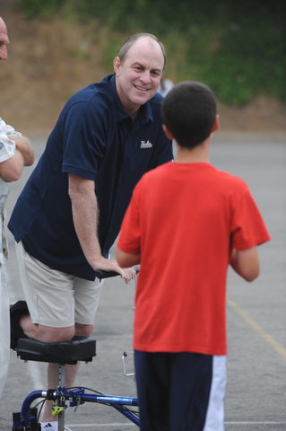 UCLA Coach Ben Howland gives Calvary Christian sixth-grader Charlie Ellis advice on the first day of his youth basketball camp at Palisades High.
