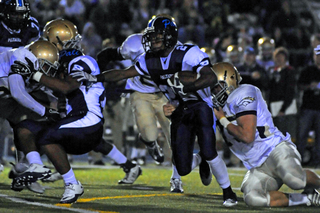 Running back Arte Miura tries to break a tackle in the backfield during Palisades' 45-16 loss to Vista Murrieta last Friday night at Stadium by the Sea.
