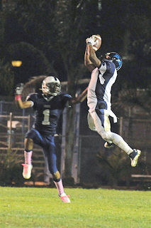Malcolm Creer goes vertical to snare one of his two interceptions in front of Venice receiver Frank Murray during last Friday's Western League opener. Palisades lost 30-13.