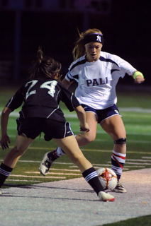 Palisades captain Kathryn Gaskin tries to deke Granada Hills' Nicole Thompson in the Dolphins' 2-0 loss November 25 at Stadium by the Sea.