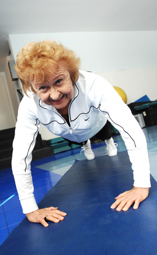 Lee Calvert does push-ups during a Fitness Forever class at the Palisades-Malibu YMCA in preparation for her next badminton tournament.