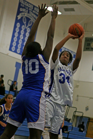 Forward Dominique Scott (right) shoots a jumper over LACES defender Itanza Lawrence during Palisades