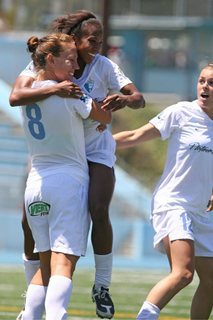 Nikki Washington jumps into the arms of Lauren Cheney (#8) after scoring in the Blues' 4-0 win last Saturday at Stadium by the Sea.