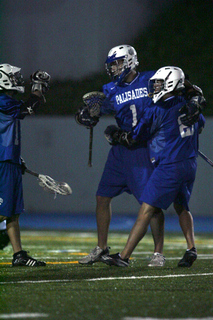 Teammates congratulate Riley Gitlin (middle) after his goal in the Dolphins' 14-4 victory over Huntington Beach at Stadium by the Sea.