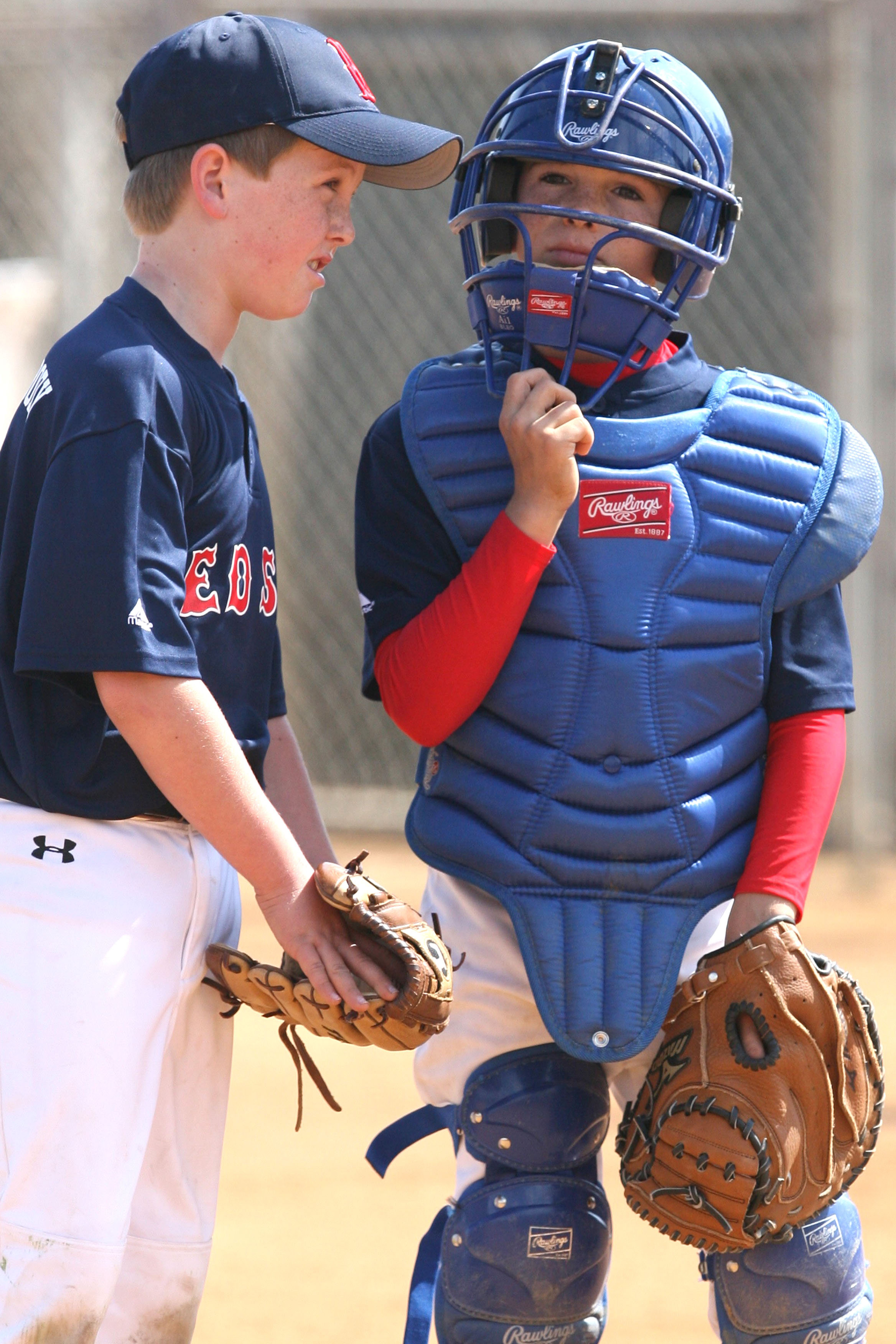 Red Sox pitcher Jack Harrington (left) consults with catcher Timothy Ellis in a PPBA Mustang Division game last Saturday at the Field of Dreams.