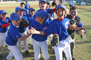 Mustang Cubs players celebrate after their 11-5 victory over the Red Sox on Wednesday at the Field of Dreams.