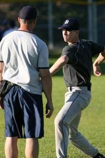 Ace right-hander Jonathan Moscot gets pitching advice from Coach Mike Voelkel at Monday's practice.