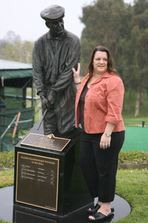 Palisadian Lisa Scott stands next to a statue of her great-uncle, golfing legend Ben Hogan, at Riviera Country Club. Scott chairs a nonprofit foundation to honor him.