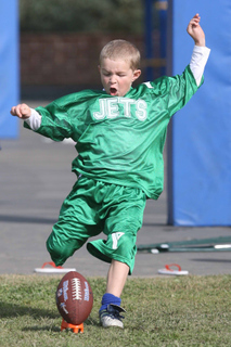 Eight-year-old Jack Nordstrom of the Jets gets his leg into a kick-off at the YMCA's Punt, Pass and Kick competition on Saturday at Marquez Elementary.