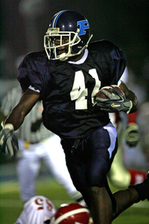 Khalid Stevens breaks a tackle on his way to the second of his three touchdowns in Palisades' 28-6 victory over Hollywood on Friday.