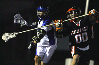 Junior attacker Warren Satz shields the ball from a Beverly Hills defender during Palisades' 16-0 victory last Friday at Stadium by the Sea.