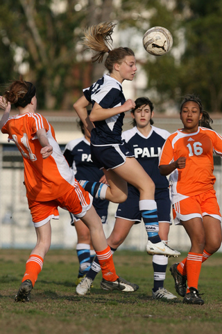 Freshman Kathryn Gaskin heads the ball to a teammate in Palisades' 3-0 Western League victory over University on Monday.