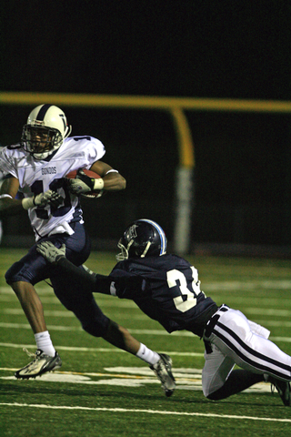 Venice tailback Jerry Johnson eludes defender Mychal Creer in the first quarter of Friday's homecoming game at Stadium by the Sea. Palisades lost 42-0.