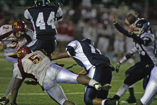 Palisades' Chris Hanuscin (#44) leaps to block a fourth-quarter field goal attempt after teammate Casey Jordan (far right) has deflected the ball.