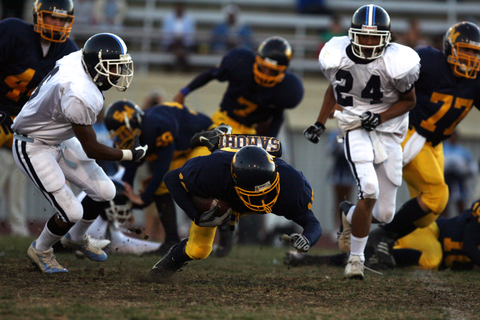 Santa Monica tailback Vince Lawrence dives for extra yardage in Friday night's intersectional game against Palisades. The Vikings won 35-0 at Santa Monica College.