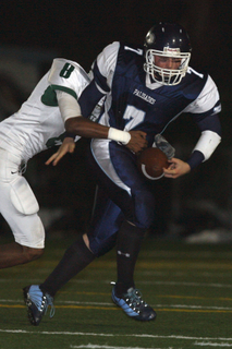 Palisades quarterback Branden Sanett tries to break free from Hamilton defensive back Anthony Williams in Friday's 28-27 homecoming defeat.