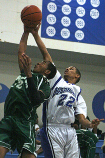 Palisades' Rico Matheney (right) tries to block a shot by Hamilton's Royce Williams in the first quarter of Monday's Western League game.