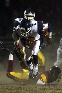 Palisades' Preon Morgan leaps over a tackler on a kickoff return in last Friday's season finale at Fairfax High. The Dolphins suffered their worst loss of the season, 55-7.