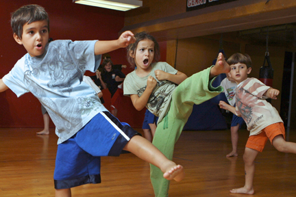 Jaden Russo (5), Rose Trisolini and Jonas Eisman (5) show off their kicking skills in the dojo.