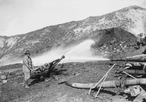 A worker using hydraulic blasting to reconfigure Santa Ynez Canyon in 1927, part of developer Alphonzo Bell's plan for a residential community. Photo: Courtesy of Eric Dugdale