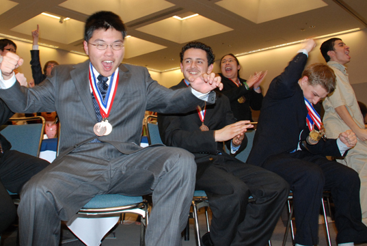 Palisades High team members leap from their chairs as they learn they have won the LAUSD
