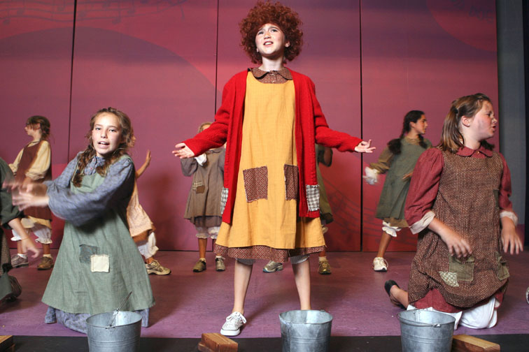 Elizabeth Ryan as Annie (center) sings a 