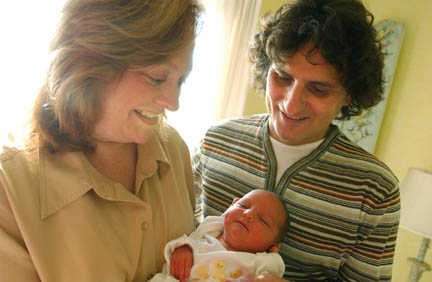 Terri Rock and husband Harry Papadopolous with daughter Melanie, the First Baby of the Year, at their home in the Via bluffs neighborhood.
